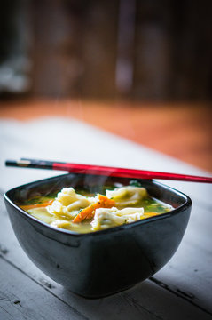Wonton soup on wooden background