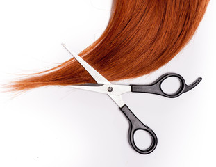 Shiny red hair and hair cutting shears