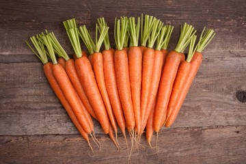 fresh carrot bunch on grungy wooden background