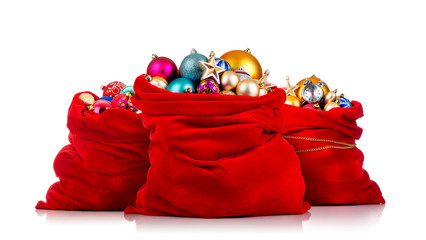 Three Santa Claus red bags with Christmas toys on white