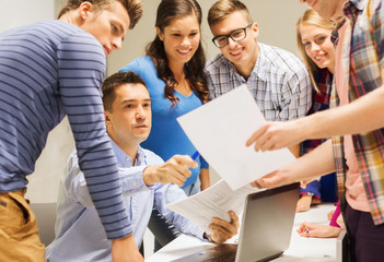 group of students and teacher with laptop