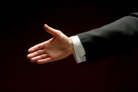 Male hands clapping on black, side-view