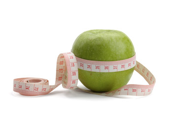 A green apple and a measuring tape, isolated on white background