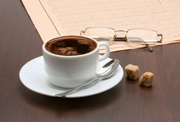 Cup of coffee and newspaper.