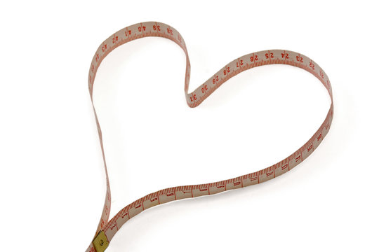 A measuring tape shaping a heart.