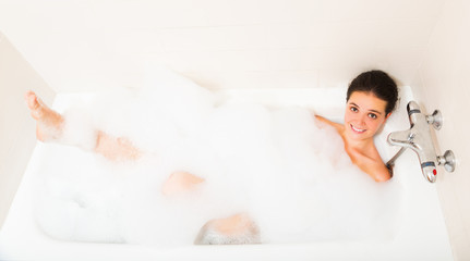 Fototapeta premium Beautiful girl laying in bath