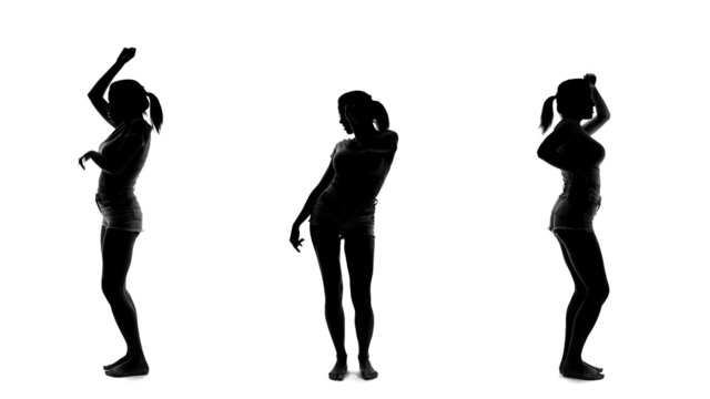 Silhouette of beautiful sexy woman dancing and listening music, 