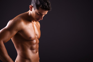 Man with beautiful torso on black background