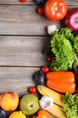 Fresh organic vegetables on wooden background