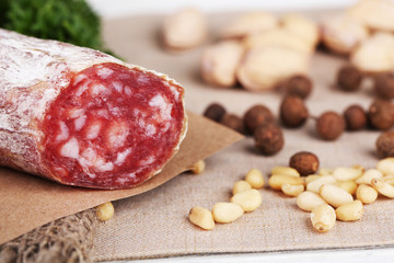 Italian salami on plate,  on wooden background