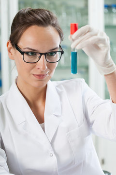 Chemist watching test tube