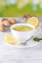 Ginger tea with lemon on table on light background