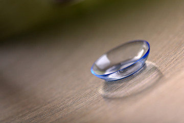 Contact lens on color background