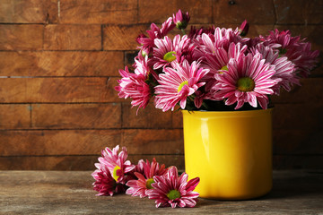 Beautiful chrysanthemum in vase on wooden background