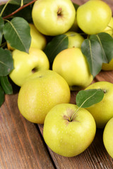 Ripe green apples on wooden background