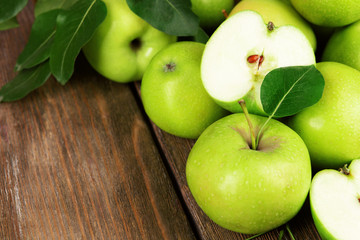 Ripe green apples on wooden background