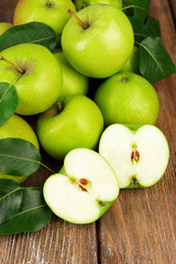 Ripe green apples on wooden background