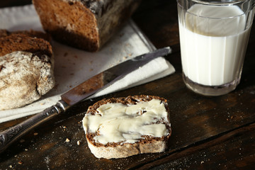 Sliced rye bread, glass of fresh milk and knife