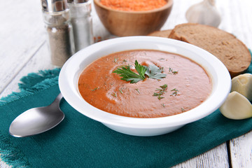 Delicious lentil cream-soup on table close-up