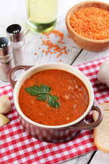 Delicious lentil cream-soup on table close-up