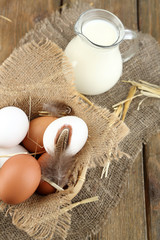 Eggs and fresh milk in glass jug,