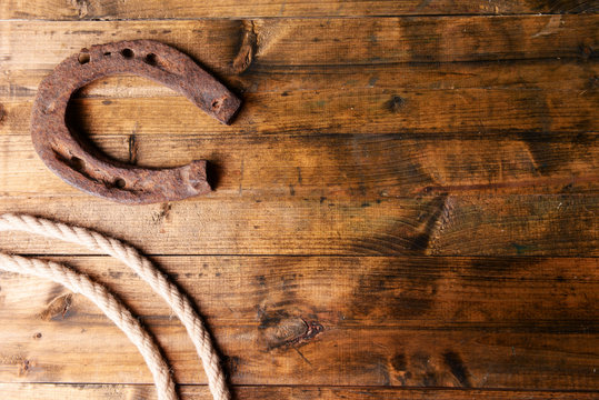 American West still life with old horseshoe and cowboy lasso