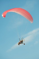 Extreme athletes paragliding in clear blue sky