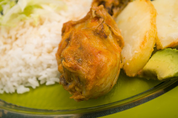 chicken served with white rice potato on a plate