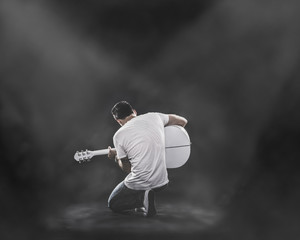 Boy playing guitar on stage