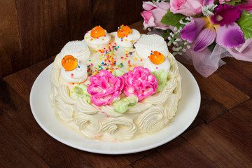 Cream cake with orange Jelly on the wooden table