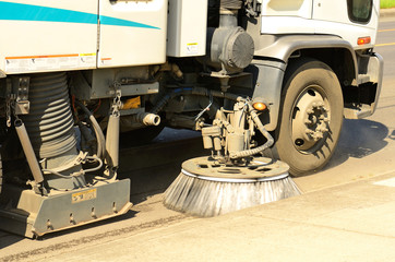 wire brush street cleaner working after a vehicle crash