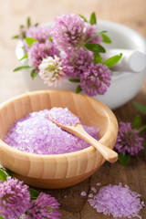 Obraz na płótnie Canvas spa with purple herbal salt and clover flowers