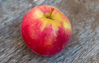 Red apple in wooden box. 
