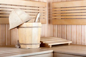 Traditional wooden sauna for relaxation with bucket of water