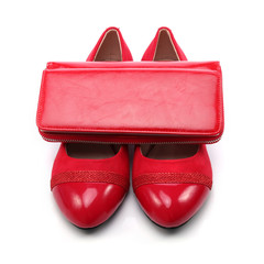 Women's shoes and a red wallet on a white background