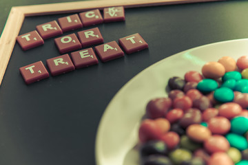 Trick or Treat word on blackboard with colorful chocolate candy5