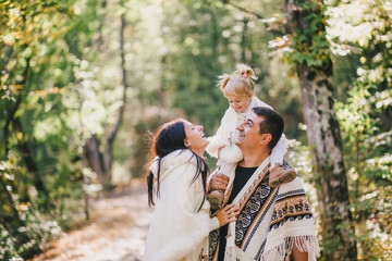 Happy family in an autumn forest