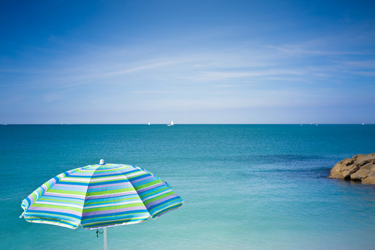 Blue Beach Umbrella Against The Sea