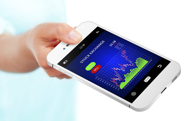 hand holding mobile phone with stock exchange chart over white