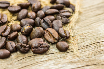 Coffee beans on sacking and wood background