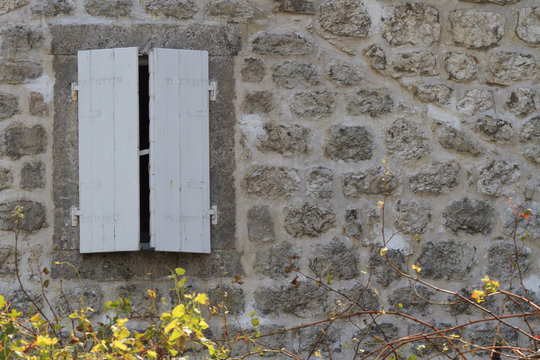 Window Closed White Shutters On A Stone Wall Of A House