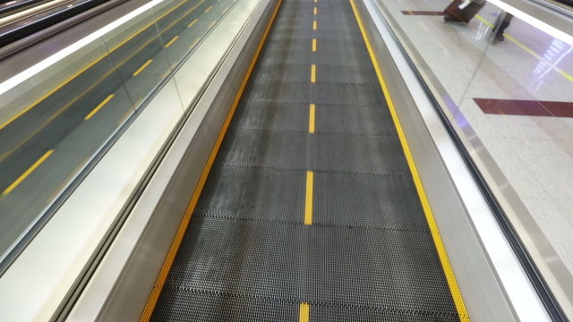 Airport moving sidewalk also travelator, walkalator and movator.