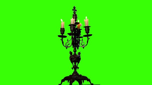 Candle in vintage candlestick on green screen