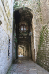 Narrow street with arches in the old town of Kotor.