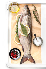 Raw fish carp with spices and herbs