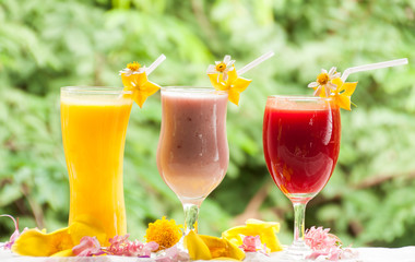 Mango juice strawberry yogurt and red cherry juice