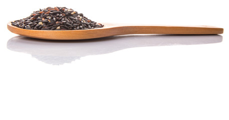 Black glutinous rice on a wooden spoon over white background