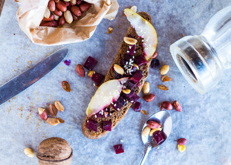 sandwich with roasted beets, nuts, pear and sesame