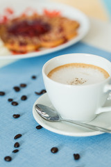 Cup of latte coffee on blue table