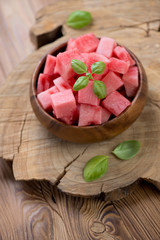 Watermelon sliced into cubes and served in a wooden bowl